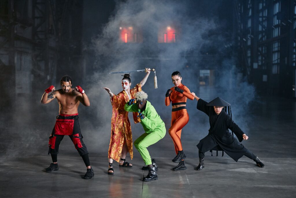 A diverse group of cosplayers posing as game characters indoors, surrounded by smoke.